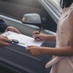 woman Sign Contract with car dealer after a auto auctions