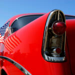A red chevy impala with American flag.