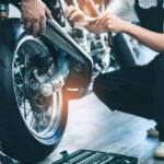 Young man repairing motobike